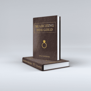 A brown leather book titled "Searching For Gold"